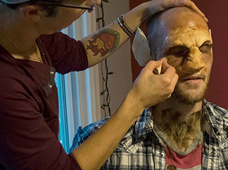 Karyn Servin applying prosthetics to one of last year's volunteer participants