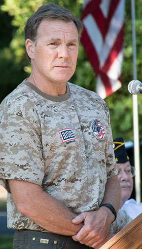 TVF&R Firefighter Mark Ross, who retired from the U.S. Air Force after 34 years of service, spoke during a September 11 Remembrance Ceremony about his experience with the USO while being deployed in the Middle East as a pararescuer. He is wearing one of the camouflage shirts TVF&R personnel have the option to wear on duty on six patriotic holidays.