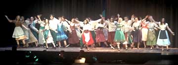The production involves nearly 60 students, including the cast of 15 lead actors, 11 in supporting roles, and 23 ensemble cast who sing and dance in the chorus, a band of seven musicians, and a crew of 18 students who work behind the scenes.