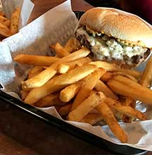 The Teemah burger comes with Bacon, Bleu Cheese Fondue & Crumbles, House Sauce, Grilled Onion & Pickle