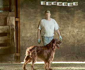 A farmer and his dog posed for a photo.