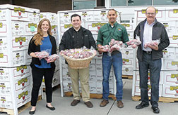 left to right Katie Pearmine, Oregon Food Bank; Steven Coppit, Market of Choice store manager; Sean Morrill, Charlie&rsquo;s Produce; and Tim Corkill, First Fruits, with 11,900 lbs of apples. Eugene-based Market of Choice, with 11 stores, chose the Cedar Mill location this year for as the site for the statewide donation. The fruit will be distributed to local food banks based on their needs. 