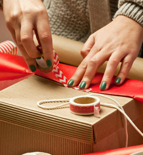 person wrapping holiday gift