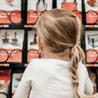 girl standing in front of giving machine
