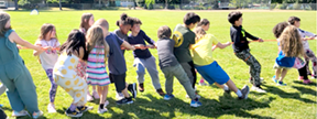 kids playing tug of war at camp
