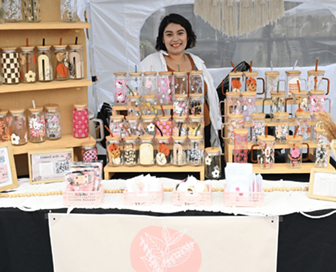 smiling person at market stall