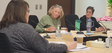 three women in meeting room
