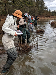 Brenneis leads students in an environmental center survey